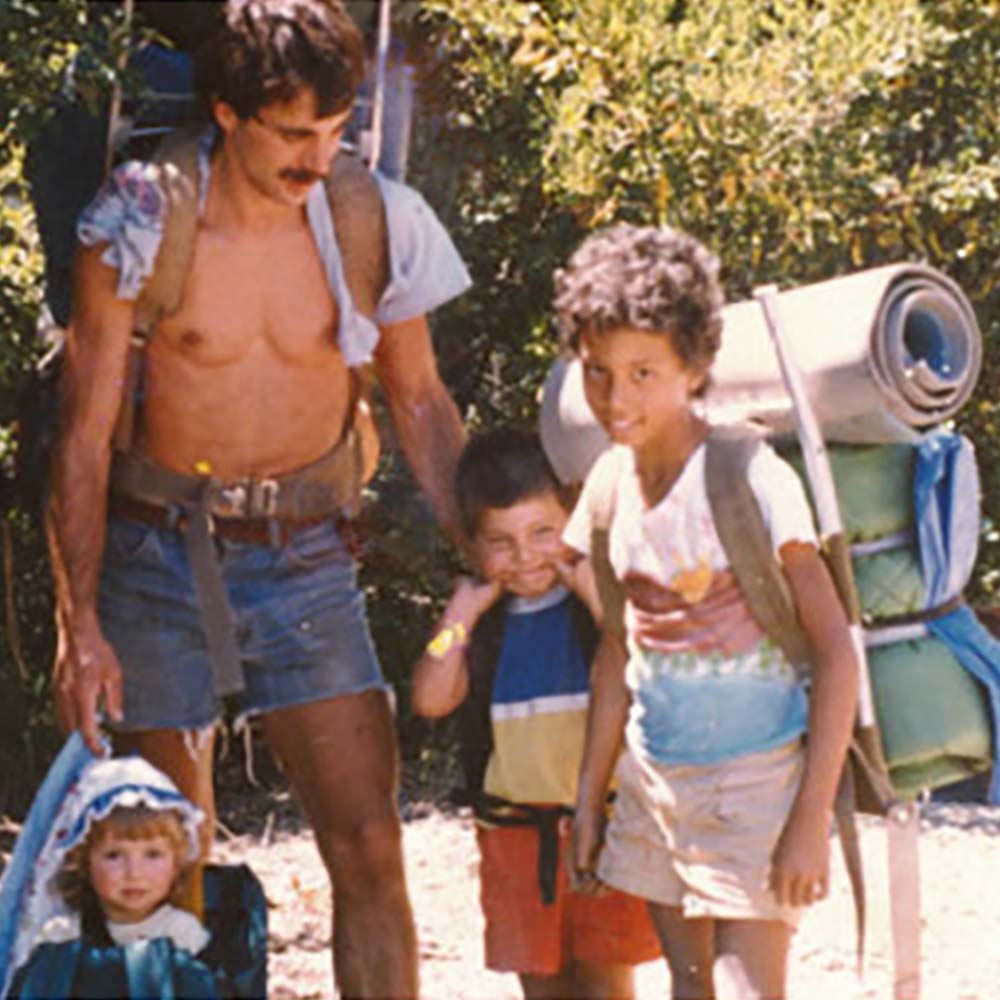 A photo of Robbin Lacy and family with backpacking gear.